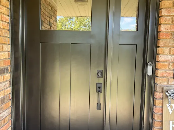 Black entry door with leaded glass insert and sidelights