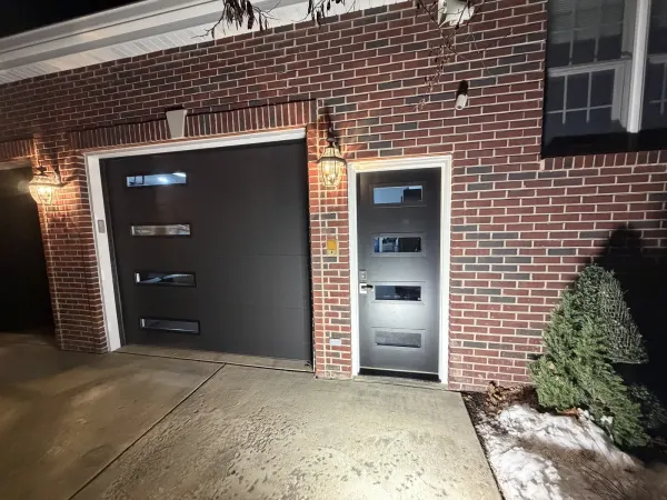Black entry door with white frame on red brick