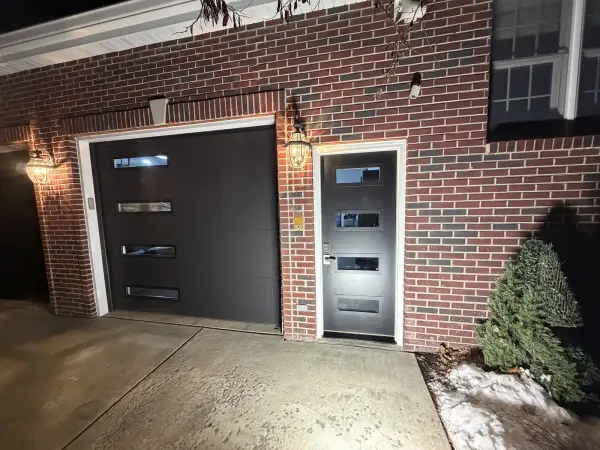 Black entry door with white frame on red brick