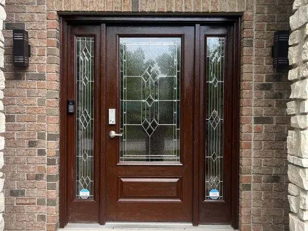 Brown traditional entry door with sidelights