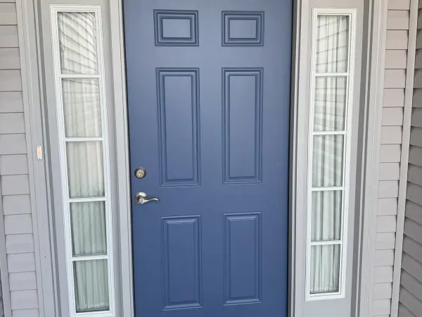 Light blue front door with transom window