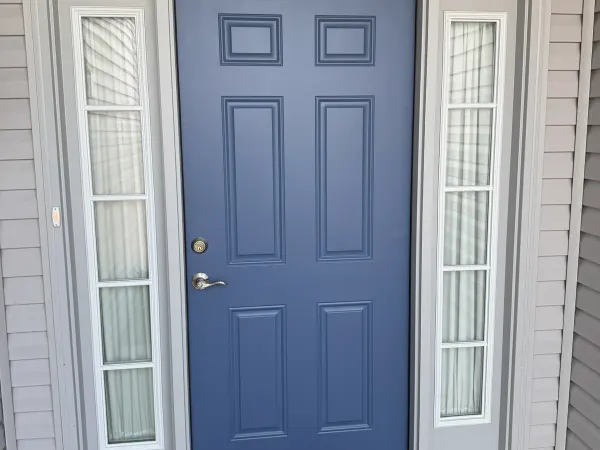 Light blue front door with transom window