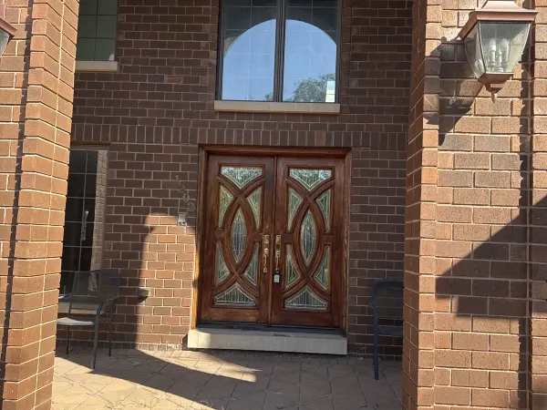 Dark wood entry door with stained glass insert