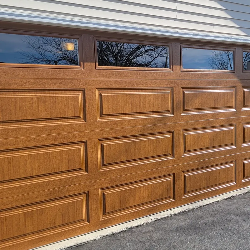 Wood-grain steel raised-panel garage door