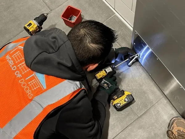 World of Doors technician performing garage door maintenance