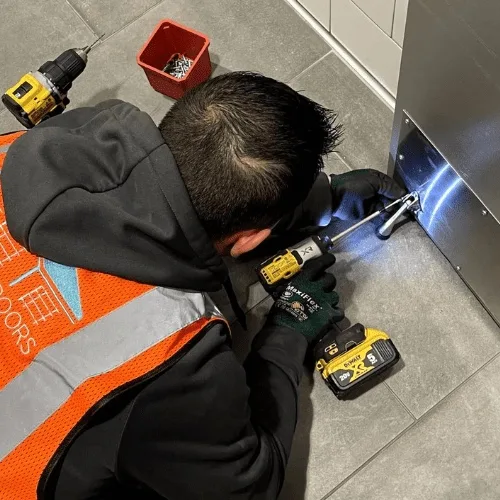 World of Doors technician performing annual maintenance on a residential garage door