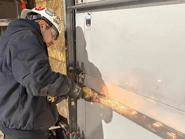 World of Doors technician repairing garage door hardware