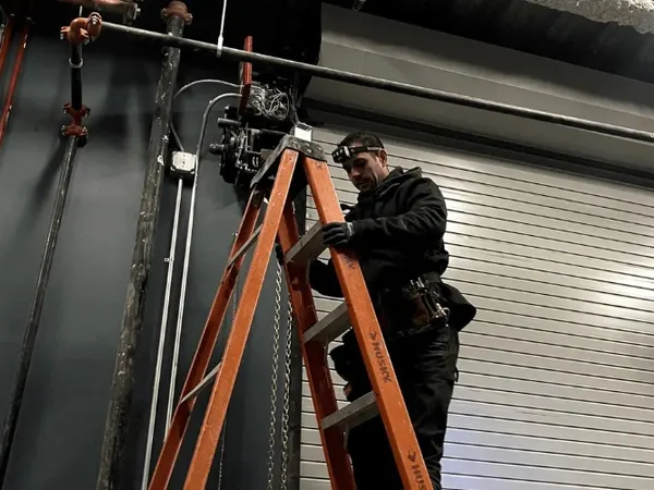 Technician servicing a commercial overhead door