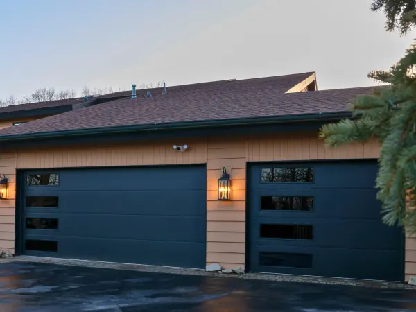 Two modern garage doors with dark glass panels
