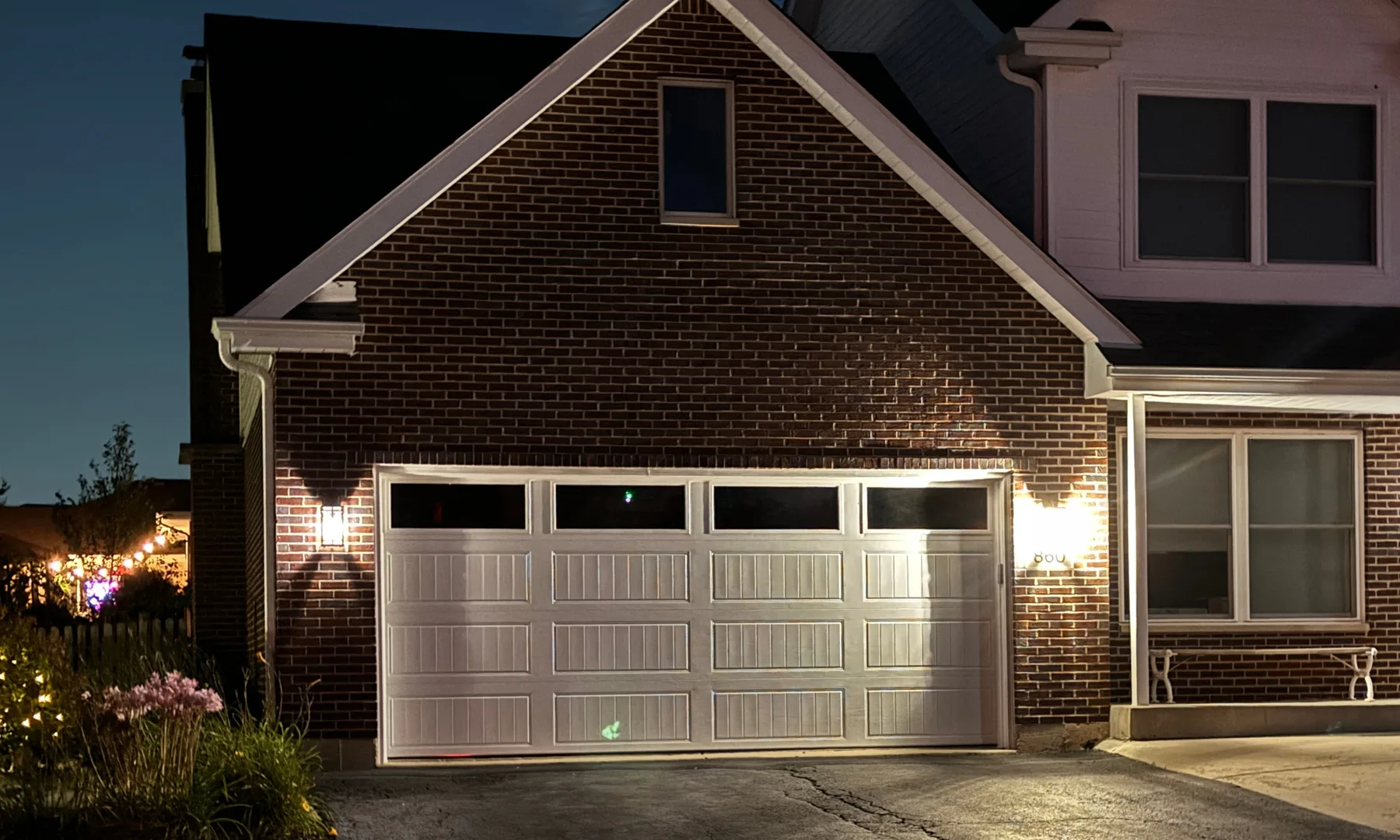 White carriage-style garage door with a top row of windows