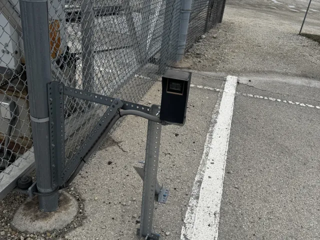 Slide-gate operator on a chain-link perimeter gate — commercial yard install. Heavy-duty operator paired with safety loops and edge sensors per UL 325.