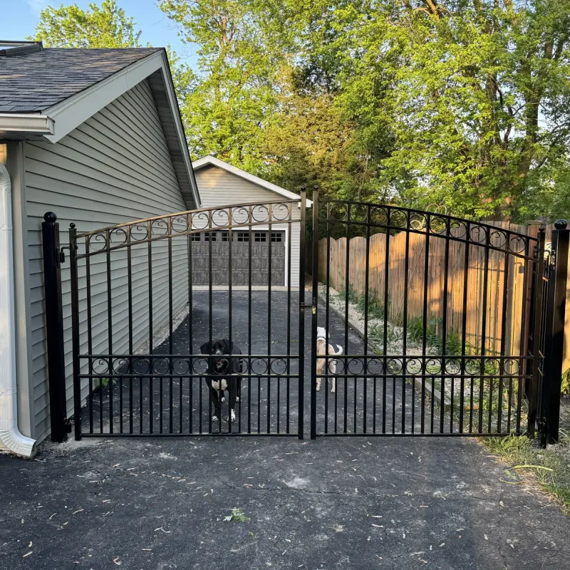 Ornamental iron driveway gate at a residential home