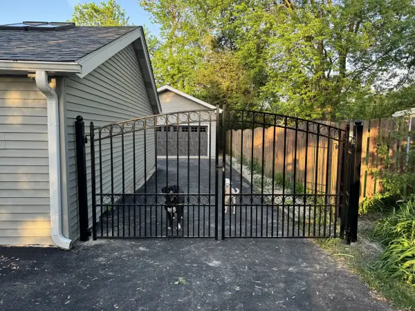 Ornamental iron driveway gate at a private residence