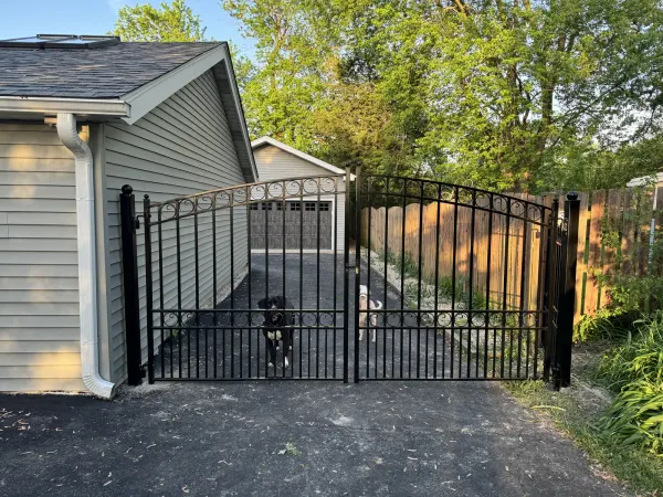 Ornamental iron driveway gate at a private residence