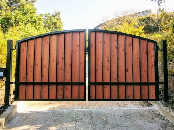 Custom wood-and-iron arched double swing gate