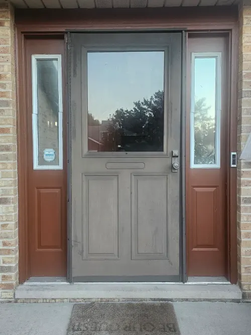 Brown dutch-style entry door with sidelights and a brown welcome mat
