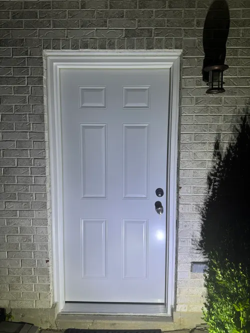 Brown two-panel entry door with a tall leaded-glass sidelight