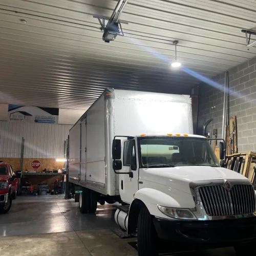 Box truck with rear roll-up cargo door at a Chicagoland yard