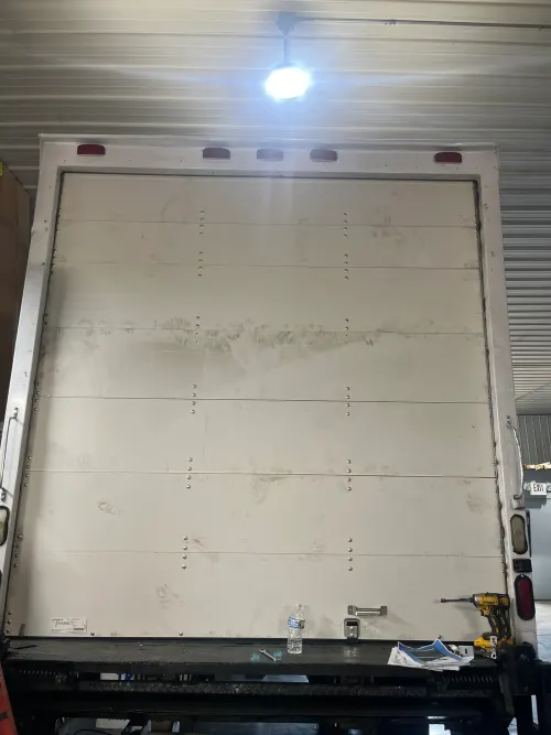 Clean white roll-up door panel on the back of a box truck