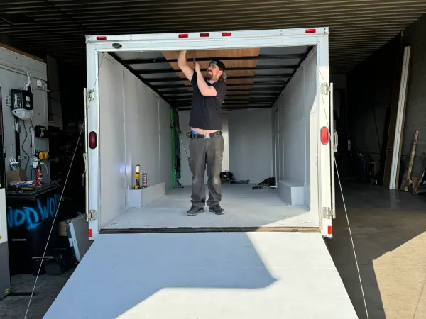 Technician completing door service inside a box truck