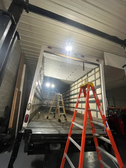Newly installed roll-up door retracted at the top of a box truck