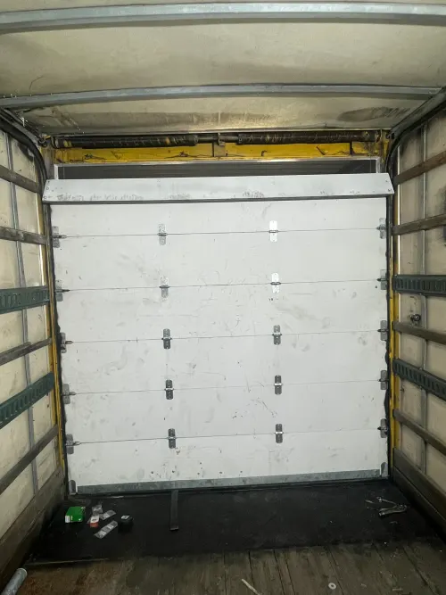 Vertical view inside a box truck cargo area with a ladder