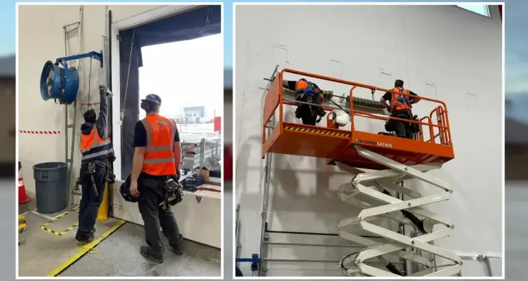 Technicians from a commercial door repair company near me performing installation and maintenance of commercial overhead doors using professional tools and equipment.