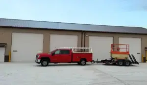 Red service truck from a trusted garage door supplier in Frankfort, prepared for commercial garage door installation.