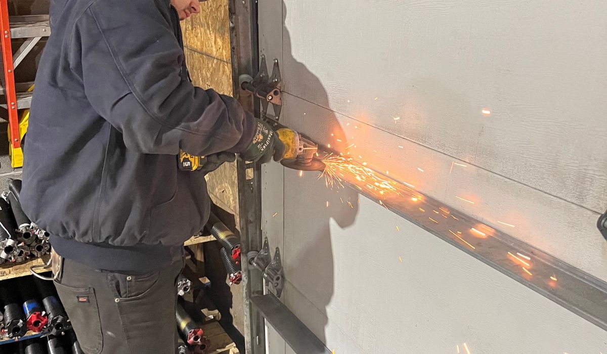 a technician is working on a commercial overhead door repair