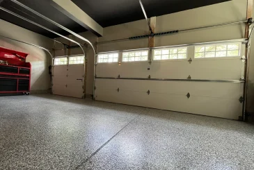 Interior view of a garage with overhead doors installed by commercial door repair companies, highlighting commercial overhead door repair services.