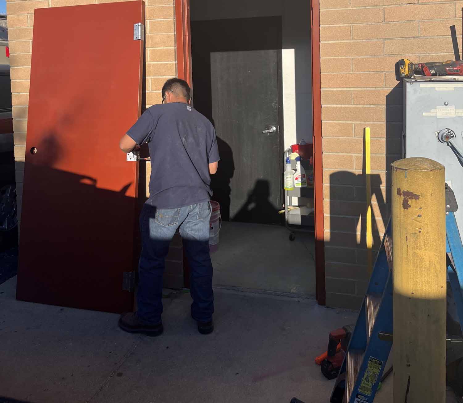 the technician is fixing the door