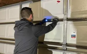 a man is measuring the balance of the garage door